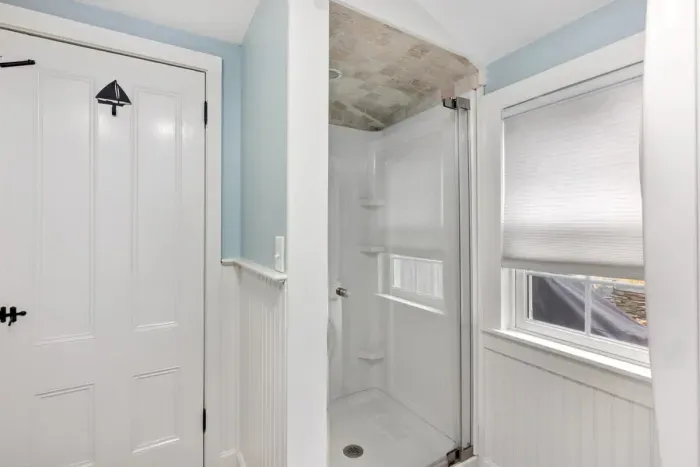 first floor bathroom with walk-in shower and laundry