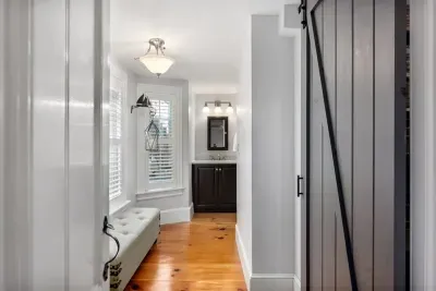 Second floor bathroom with double vanity sink and tiled shower