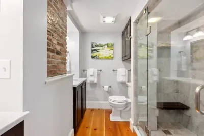Second floor bathroom with double vanity sink and tiled shower
