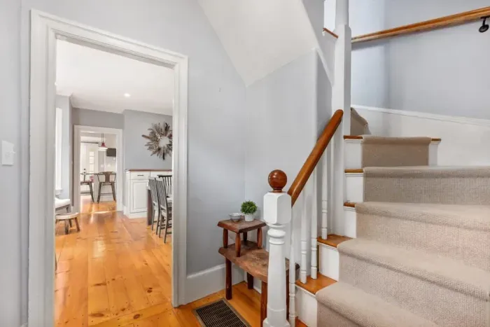 Carpeted stairs going to the second floor