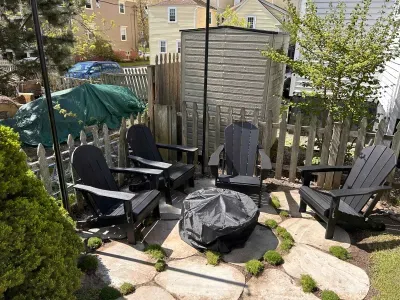 The backyard sitting area with string light, gas grill, and a wood burning fireplace!