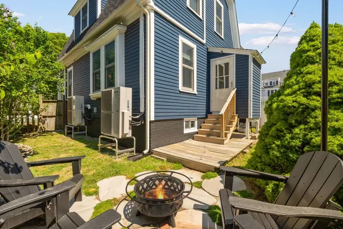The backyard sitting area with string light, gas grill, and a wood burning fireplace!