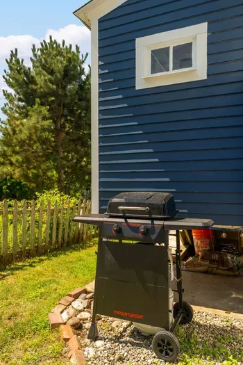 The backyard sitting area with string light, gas grill, and a wood burning fireplace!