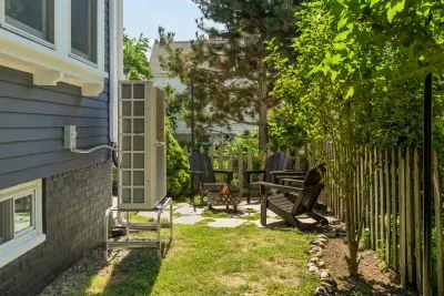 The backyard sitting area with string light, gas grill, and a wood burning fireplace!