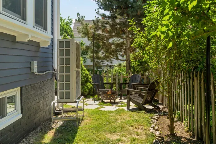 The backyard sitting area with string light, gas grill, and a wood burning fireplace!