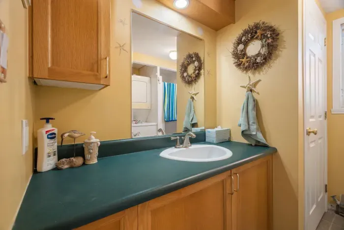 First floor full bathroom with standing shower and washer/dryer unit