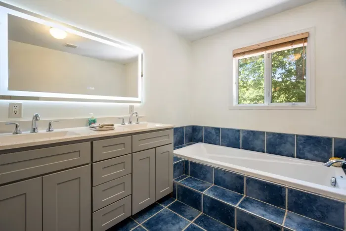 Second floor full bathroom with soaking tub and standing shower. Access to the bathroom from master and from hallway