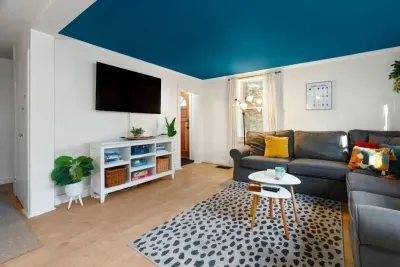 Bright and open living room with wraparound couch with pull-out! Great space for entertaining and games with the family.