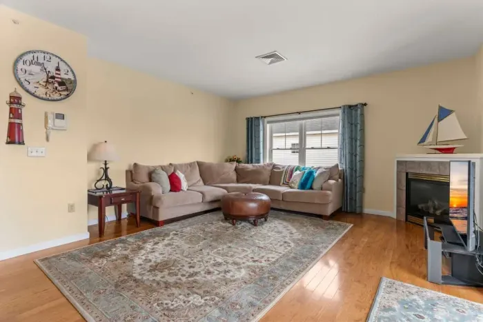 Open living room with gas fireplace and slider onto your private deck. Cozy up and relax.