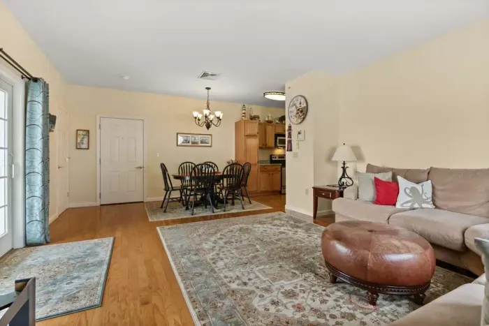 Open living room with gas fireplace and slider onto your private deck. Cozy up and relax.