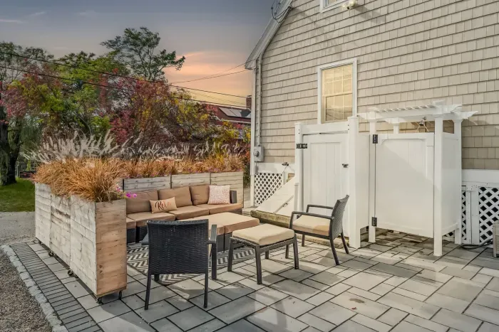 Back patio with large sectional, grill, and outdoor shower!
