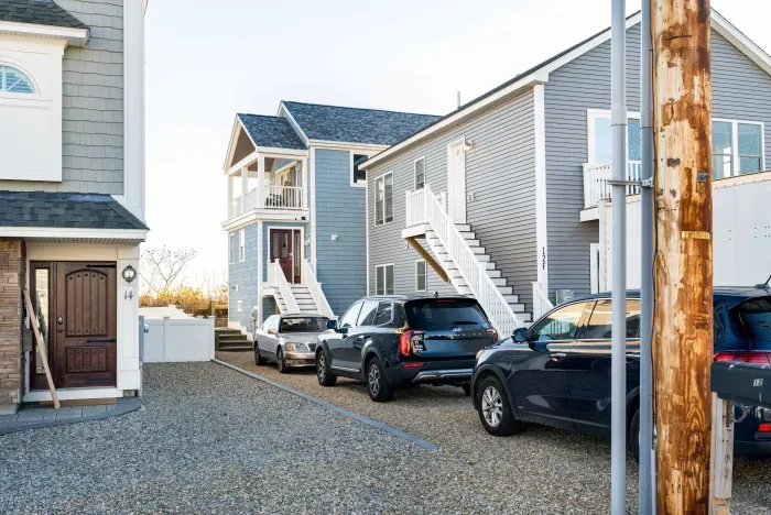 The back building is the home. All 3 cars pictured are in the designated driveway