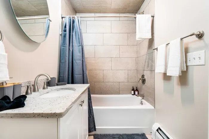 The second floor bathroom with tiled shower/tub combo! Clean towels are provided. 