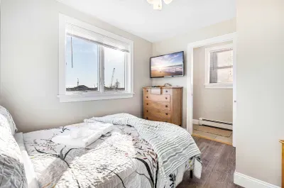 The primary bedroom! This room features a double bed, half bathroom, and a smart TV. There is a ceiling fan in this room as well. Clean linens and towels provided.