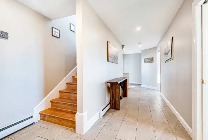 Second level hallway from main entrance by the driveway. The stairs lead up to the main living area. 