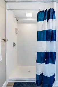 Large stand up shower on the lower level, this bathroom also has the washer and dryer for guest use.  Clean towels provided.