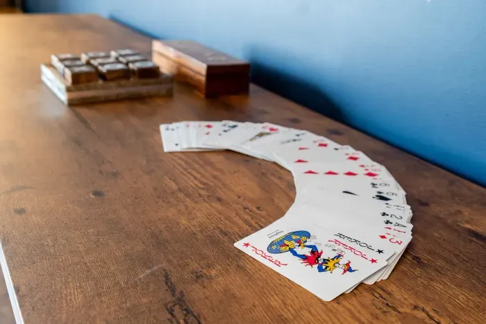 "The Game Room" features foosball, pool, wall-mounted connect 4, checkers, chess, dominoes, tic-tac-toe, a bar table with 3 stools, wall-mounted TV, slider leading to private balcony and a “work-from-home” desk