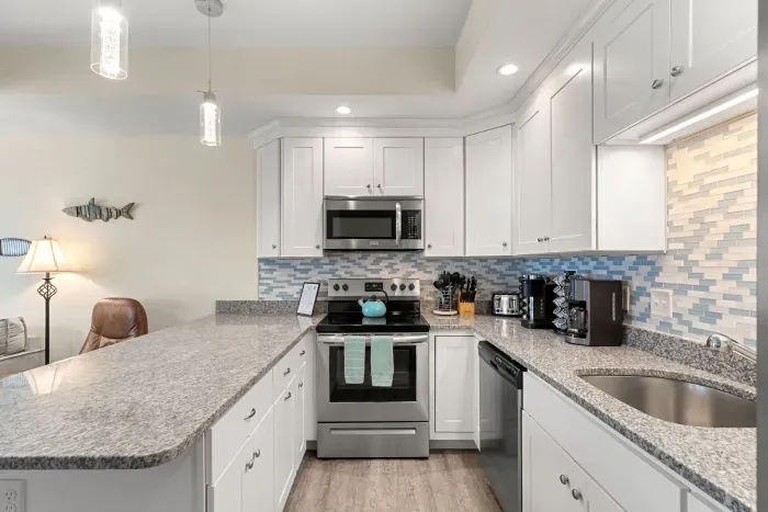 First floor living room and fully stocked kitchen, with flat screen smart TV, 4 barstools, reclining chair and kitchen table.