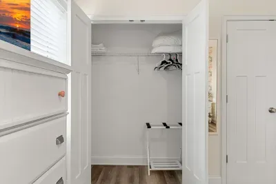 Primary bedroom with king bed, two large closets, smart TV and en-suite bathroom.