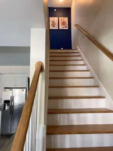 Stairs leading to the second level, home to "The Game Room", two more bedrooms, a full bathroom, and private balcony