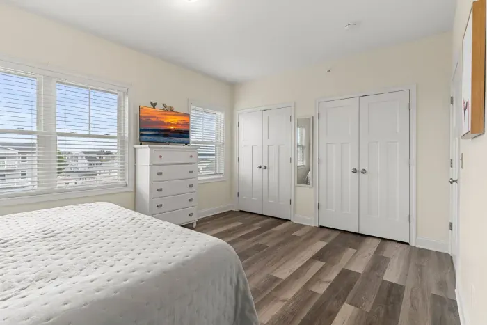 Primary bedroom with king bed, two large closets, smart TV and en-suite bathroom.