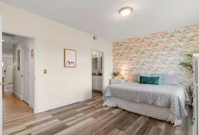 Primary bedroom with king bed, two large closets, smart TV and en-suite bathroom.