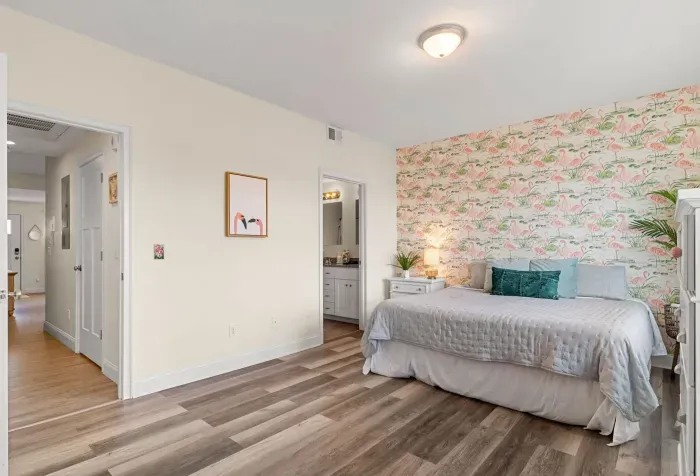 Primary bedroom with king bed, two large closets, smart TV and en-suite bathroom.