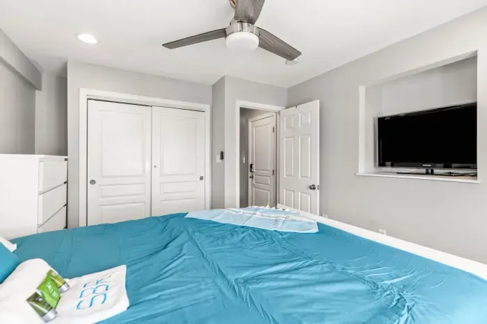 Queen bedroom with a smart TV, ceiling fan, and peek-a-boo ocean views! Clean linens and towels provided for all guests