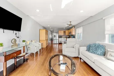 Open concept living area with a smart TV, Queen sleeper sofa, and updated kitchen