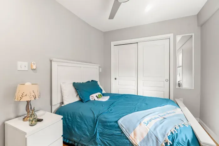 Queen bedroom with a smart TV and ceiling fan. Clean linens and towels provided for all guests