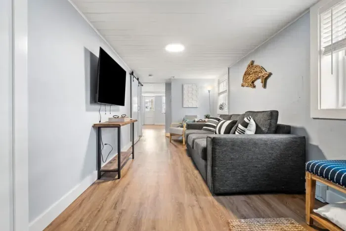 Living room with couch and smart Roku TV to enjoy your streaming services and basic cable.