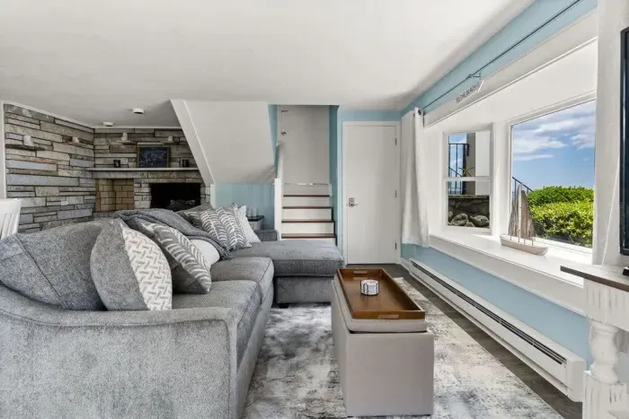 Open kitchen & living room with sleeper sofa, 50" smart TV, high-efficiency mini-split for AC/heat, and stunning views of the ocean.