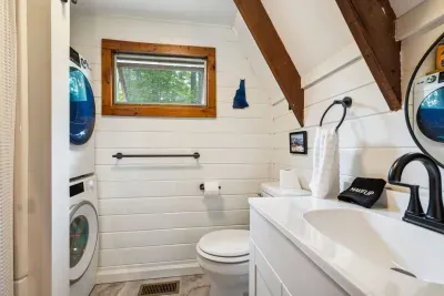 The bathroom! This bathroom has an apartment sized washer and dryer and standing shower. Clean bath and hot tub towels provided for all guests.