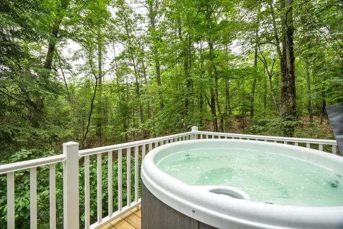 The hot tub fits 4 adults comfortably and looks over a small stream and out into the woods! PLEASE NOTE there are neighbors to the right of the home and hot tub. The hot tub cover does fold upward to provide some privacy.