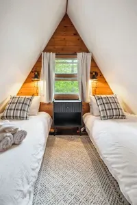 The twin room! Please note this room is small but the perfect place to rest after a day of adventure. 100% cotton bedding, tower fan, blackout curtains, and clean linens provided.