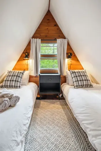 The twin room! Please note this room is small but the perfect place to rest after a day of adventure. 100% cotton bedding, tower fan, blackout curtains, and clean linens provided. 