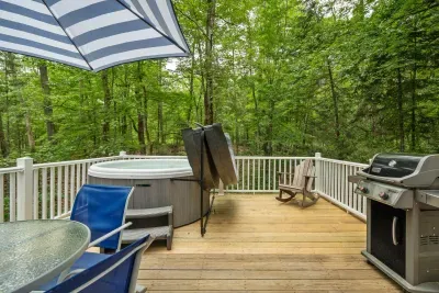 The deck! The hot tub is professionally maintained. There is seating for 4, and a Weber gas grill out here.