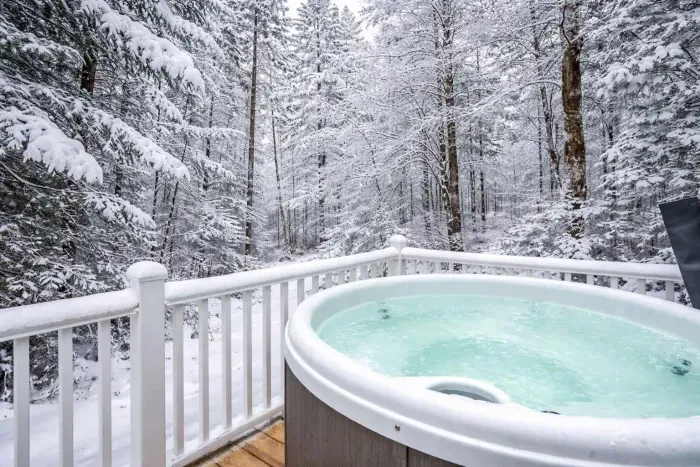 The hot tub fits 4 adults comfortably and looks over a small stream and out into the woods! PLEASE NOTE there are neighbors to the right of the home and hot tub. The hot tub cover does fold upward to provide some privacy.