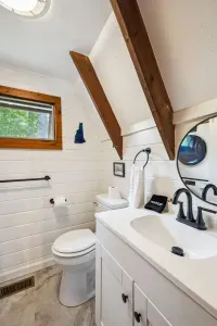 The bathroom! This bathroom has an apartment sized washer and dryer and standing shower. Clean bath and hot tub towels provided for all guests.