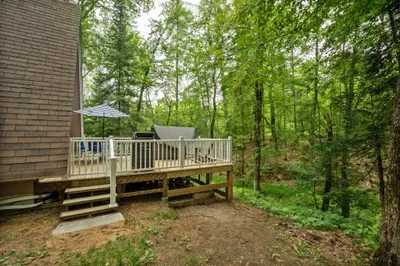 The deck overlooking the stream and woods! Please note there are neighbors on this side of the house. They are very nice!