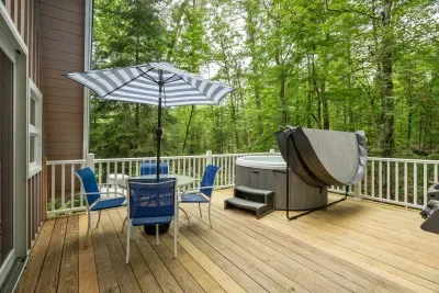 The deck! The hot tub is professionally maintained. There is seating for 4, and a Weber gas grill out here.
