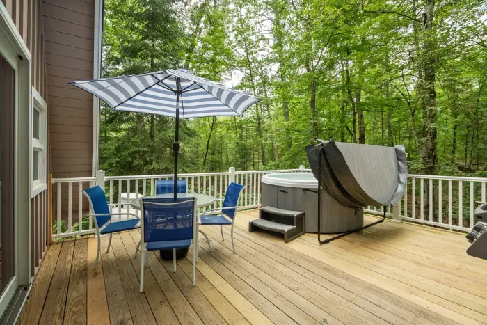 The deck! The hot tub is professionally maintained. There is seating for 4, and a Weber gas grill out here. 
