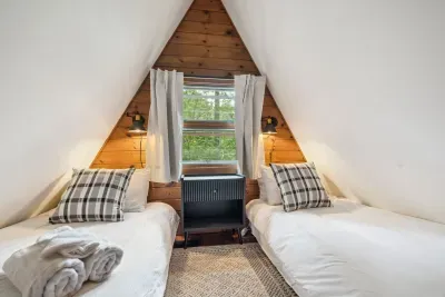 The twin room! Please note this room is small but the perfect place to rest after a day of adventure. 100% cotton bedding, tower fan, blackout curtains, and clean linens provided.