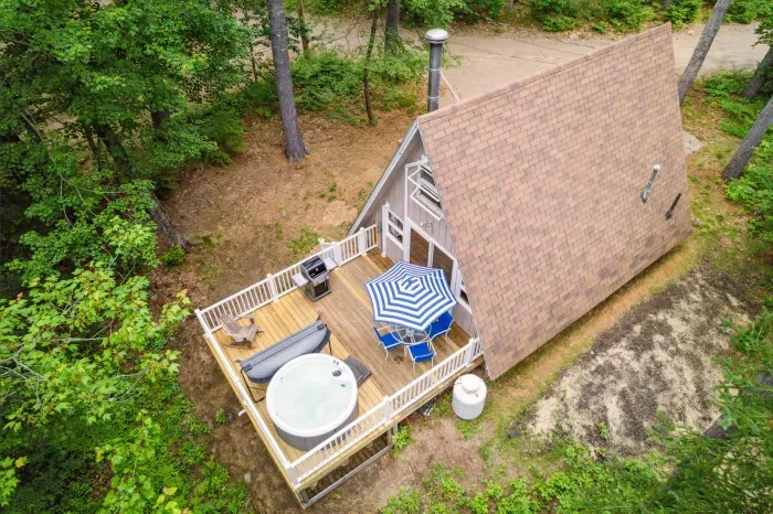 An aerial of Camp Conway and the deck! This deck has outdoor seating for 4, a hot tub, and a Weber gas grill!