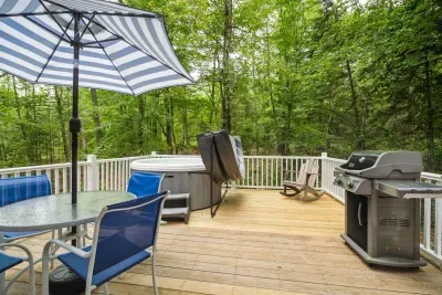 The deck! The hot tub is professionally maintained. There is seating for 4, and a Weber gas grill out here.