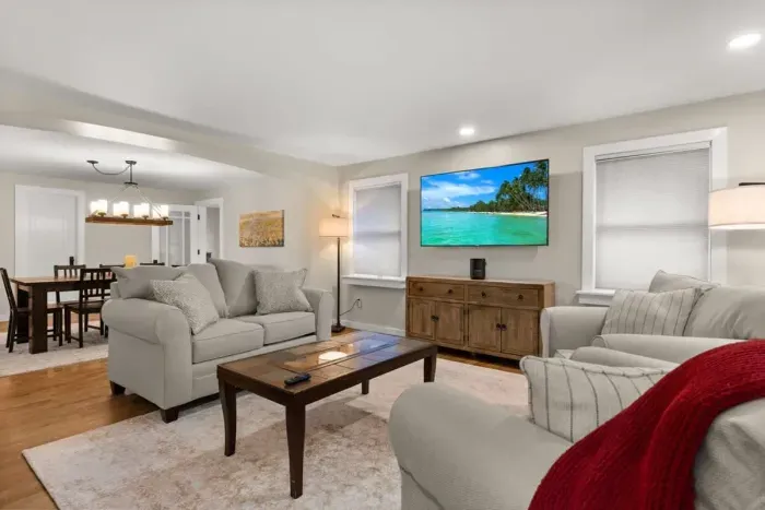 Relax and unwind in our cozy living room, complete with comfortable seating and a large TV for your entertainment.