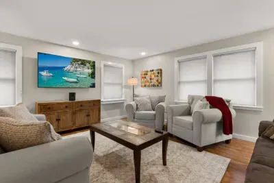 Relax and unwind in our cozy living room, complete with comfortable seating and a large TV for your entertainment.