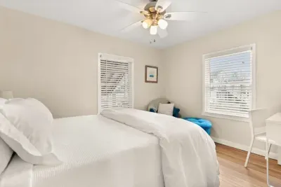 This 2nd cozy bedroom on the 1st floor features a comfortable queen-size bed and a TV, perfect for a relaxing evening after a day of exploring