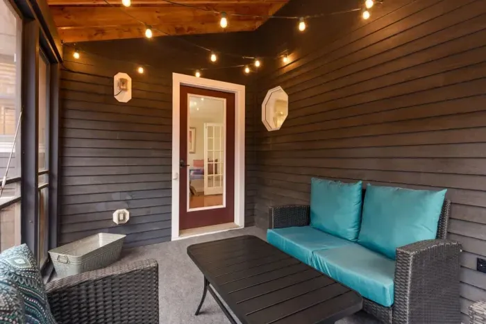 Fully enclosed, cozy and bright 3-season porch, with a rustic yet modern feel.