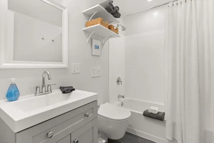Full tub and shower located in the spacious bathroom of the third bedroom.